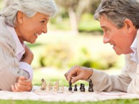 Elderly couple playing chess